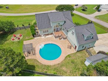 Stunning aerial view of home featuring a private pool, outdoor fireplace, and meticulously landscaped backyard at 5405 Overdale Ln, Raleigh, NC 27603
