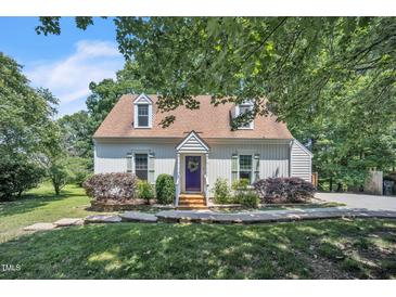 Charming home featuring dormer windows, a peaked roof, and a welcoming purple front door at 6328 Jones Farm Rd, Wake Forest, NC 27587