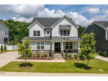 Charming two-story home with stone accents, manicured lawn, and a welcoming front porch at 74 Permit Ct, Chapel Hill, NC 27517