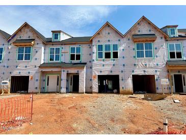 New townhomes under construction featuring covered garages, craftsman windows and modern architectural design at 87 Ripple Way # 214, Clayton, NC 27520