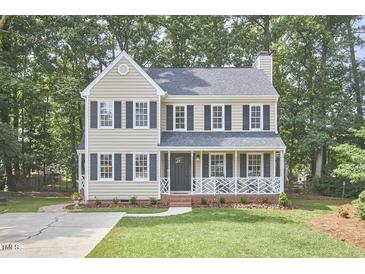Charming two-story home with a manicured lawn, a welcoming front porch, and classic black shutters at 106 Rock Nest Ct, Morrisville, NC 27560