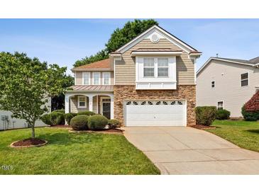 Charming two-story home with stone accents, a well-manicured lawn, and a two-car garage at 120 Ryder Cup Cir, Raleigh, NC 27603