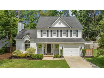 Charming two-story home with white siding, black shutters, and an attached two-car garage at 12117 Inglehurst Dr, Raleigh, NC 27613