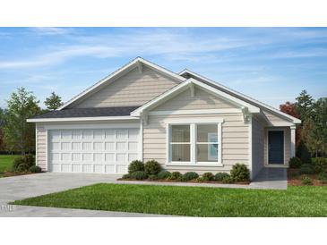 Charming single-story home features a two-car garage, neutral siding, and a well-manicured front yard at 125 Fraiser Fir Way, Lillington, NC 27546