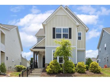 Charming two-story home with a landscaped front yard and inviting entrance at 141 Beldenshire Way, Holly Springs, NC 27540