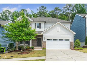 Charming two-story home featuring a two-car garage, brick accents, and a well-manicured lawn at 2619 Bordwell Grant Dr, New Hill, NC 27562