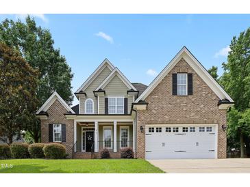 Charming two-story home with brick and siding, featuring a two-car garage and well-manicured lawn at 37 Meadow Oaks Cir, Smithfield, NC 27577