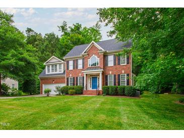 Charming two-story red brick home with a blue front door and well-manicured lawn at 3908 Sterling Ridge Ln, Durham, NC 27707