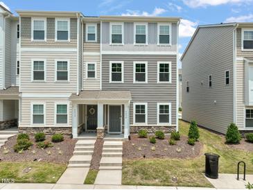 Attractive townhouse with manicured landscaping, visible in this sunny exterior view at 5430 Crescent Square St, Raleigh, NC 27616