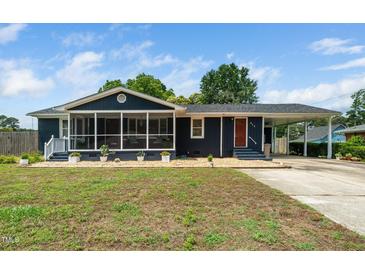 Charming single-story home boasts a screened porch, carport, and manicured landscaping at 914 Forest Dr, Garner, NC 27529