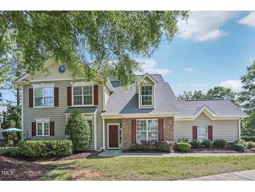 Charming two-story home with brick and siding, landscaped yard, and inviting front entrance at 9530 Vira Dr, Raleigh, NC 27617