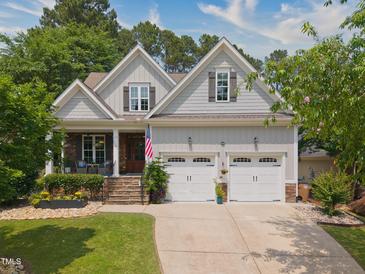 Charming two-story home with a two-car garage, a landscaped yard, and a welcoming front porch at 1161 Golden Star Way, Wake Forest, NC 27587