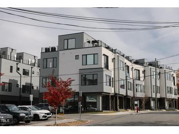Modern townhome exterior with a gray and white color scheme and a red tree in the front at 3007 Corbell Rd, Durham, NC 27701