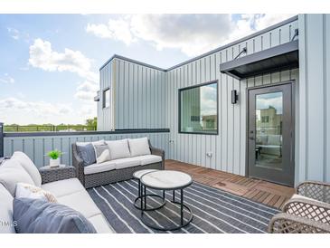 Relaxing rooftop deck featuring stylish outdoor furniture and views at 3007 Corbell Rd, Durham, NC 27701