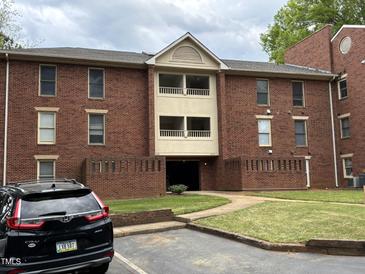 Brick apartment building with balconies and walkway entrance at 3601 Helix Ct # 301, Raleigh, NC 27606
