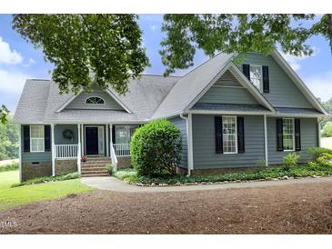 Charming home with gray siding, black shutters, well-maintained landscaping and inviting front entrance at 3684 Ben Mil Ct, Franklinton, NC 27525
