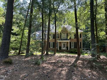 Charming brick two-story home with a manicured lawn and mature trees at 5109 Makena Dr, Raleigh, NC 27615