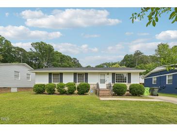 Charming single story home featuring a well-manicured lawn and inviting curb appeal at 555 Dacian Rd, Raleigh, NC 27610
