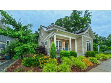 Charming craftsman home with manicured landscaping and inviting front porch featuring a painted blue door at 729 Lorentello Cir, Hillsborough, NC 27278