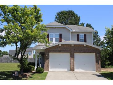 Charming two-story home with a well-maintained lawn, a two-car garage and brick accents at 740 Obsidian Way, Durham, NC 27703