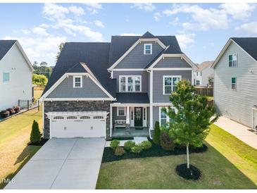 Charming two-story home featuring a stone accent garage and a beautifully landscaped front yard at 808 Buckner Ct, Fuquay Varina, NC 27526