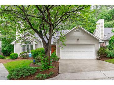 Charming home with a two-car garage, lush green lawn, mature trees, and well maintained landscaping at 100 Culbreth Rd # C, Chapel Hill, NC 27516