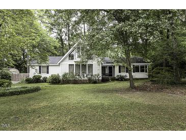Charming single-story home with a lush green lawn and mature trees surrounding the property at 105 Litchfield Ct, Rocky Mount, NC 27803