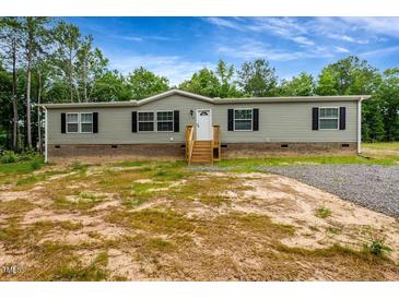 Charming single-story home with gray siding, black shutters, and a welcoming front porch at 150 Will Woods Way, Franklinton, NC 27525