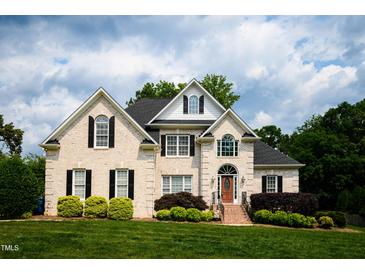 Charming two-story brick home with manicured lawn and mature landscaping at 3021 Glenwood Dr, Durham, NC 27705