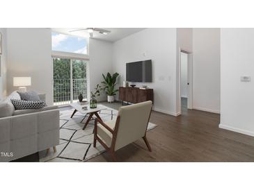 Bright living room with modern decor, hardwood floors, and large sliding doors to a balcony at 600 S Duke St # 24, Durham, NC 27701
