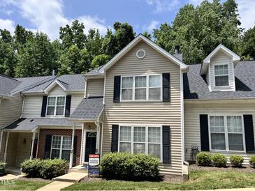 Traditional townhouse featuring neutral siding, black shutters, and a well-manicured lawn at 7331 Bonnie Ridge Ct, Raleigh, NC 27615
