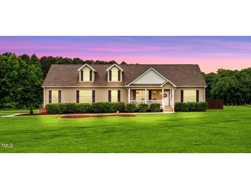 Charming home featuring a spacious front yard, manicured landscaping, and a welcoming covered porch at 9300 Lake Wheeler Rd, Fuquay Varina, NC 27526