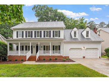 Inviting two-story home with a charming front porch and a two-car garage at 9425 Brimstone Ln, Raleigh, NC 27613
