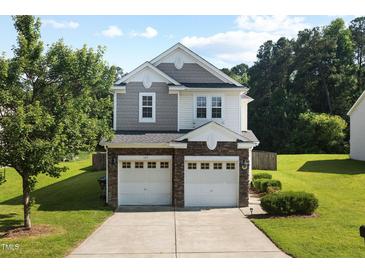 Charming two-story home with a well-manicured lawn, a two-car garage, and lovely landscaping at 109 Citrine Ct, Durham, NC 27703