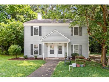 Charming duplex features a manicured lawn, and traditional architectural details and is shaded by mature trees at 118 Rhum Pl, Garner, NC 27529