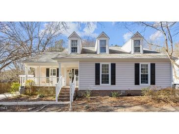 Charming home featuring dormer windows, black shutters, and a welcoming front porch at 1536 Maybrook Dr, Raleigh, NC 27610