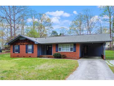 Charming brick home featuring a carport and well-maintained front yard, perfect for comfortable suburban living at 1813 Grady Dr., Durham, NC 27712