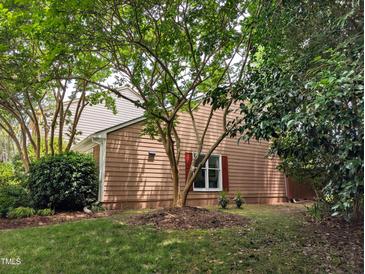 Charming home exterior with mature tree and landscaped yard at 186 St. Andrews Ln, Chapel Hill, NC 27517