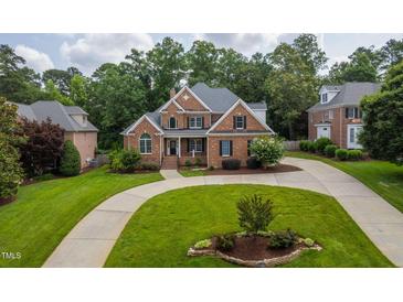 Beautiful two-story brick home with mature trees and a circular driveway at 209 Bailey Ridge Dr, Morrisville, NC 27560