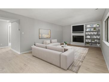 Bright living room with a fireplace, built-in shelves, and neutral decor creates a welcoming space at 3088 Colony Rd # A, Durham, NC 27705