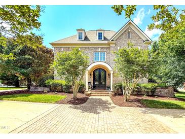 Charming brick home with well-manicured landscaping and a welcoming entrance, perfect for Gathering living and curb appeal at 6005 Carlyle Dr, Raleigh, NC 27614
