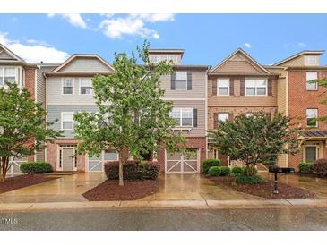 Charming townhome exterior featuring diverse architectural styles, manicured landscaping, and inviting curb appeal at 615 Carlton Commons Ln, Cary, NC 27519