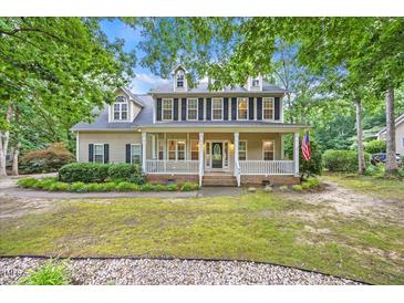 Charming two-story home featuring a welcoming front porch and well-maintained landscaping at 618 Durwood Dr, Raleigh, NC 27603