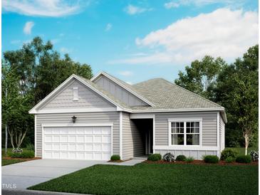 Charming single-story home with a two-car garage and neatly landscaped front yard at 708 Shepards Rock Dr, Zebulon, NC 27597