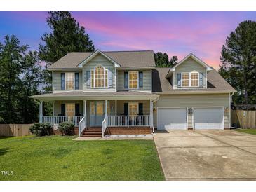 Charming two-story home with a welcoming front porch and well-manicured lawn at 105 Rolling Stone Ct, Sanford, NC 27332