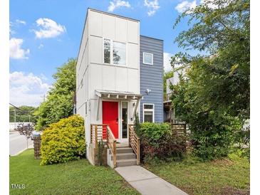 Modern two-story home with a red front door, minimalist design, and a well-manicured lawn at 1314 S East St, Raleigh, NC 27601