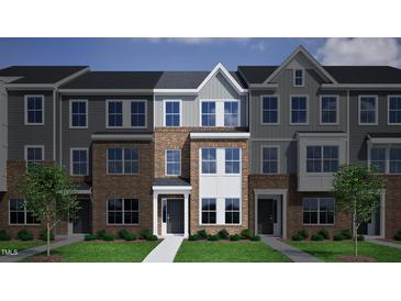 Beautiful brick townhome featuring a covered entryway and large, bright windows at 380 Chesapeake Commons St # 129, Garner, NC 27529