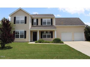 Charming two-story home featuring black shutters, a two-car garage, and a well-manicured front lawn at 417 Downing Glen Dr, Morrisville, NC 27560