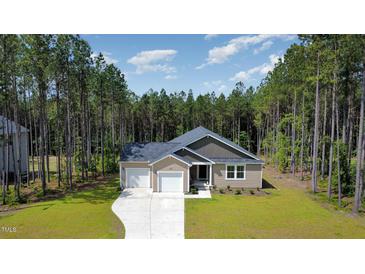 Inviting single-story home boasting a two-car garage, manicured lawn, and a blend of light and dark siding at 108 Rocking Horse Ln, Sanford, NC 27332