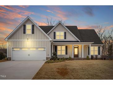 Charming home featuring a covered porch and a two-car garage at 1119 Brookfield Dr, Gibsonville, NC 27249